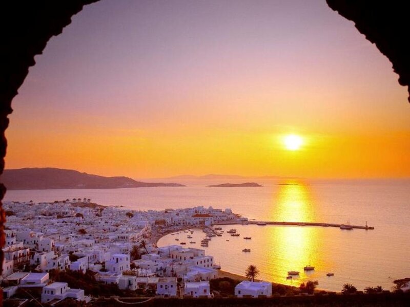 Sunset over Coastal Town — Orange, Serene, Photograph, Sea