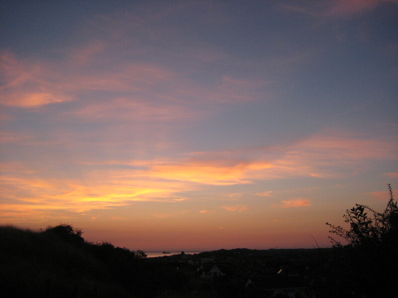 Sunset over Coastal Town — Orange, Serene, Photograph, Sky