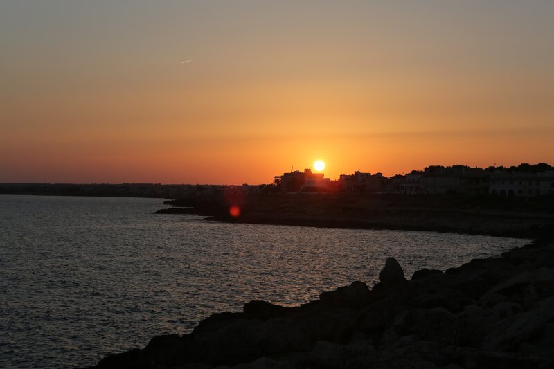 Sunset over Coastal Town — Orange, Serene, Photograph, Sun, Sea
