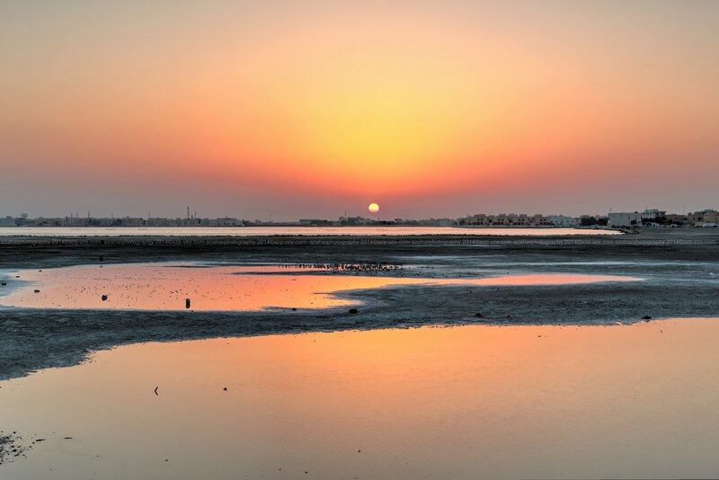 Sunset over Coastal Town — Orange, Serene, Photograph, Sun, Water