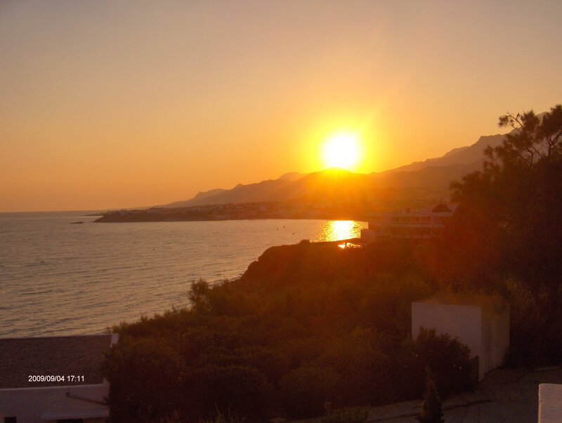 Sunset over Coastal Town — Orange, Serene, Photograph