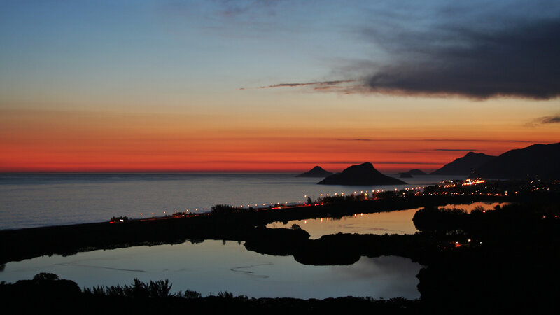 Sunset over Coastal Town — Orange, Serene