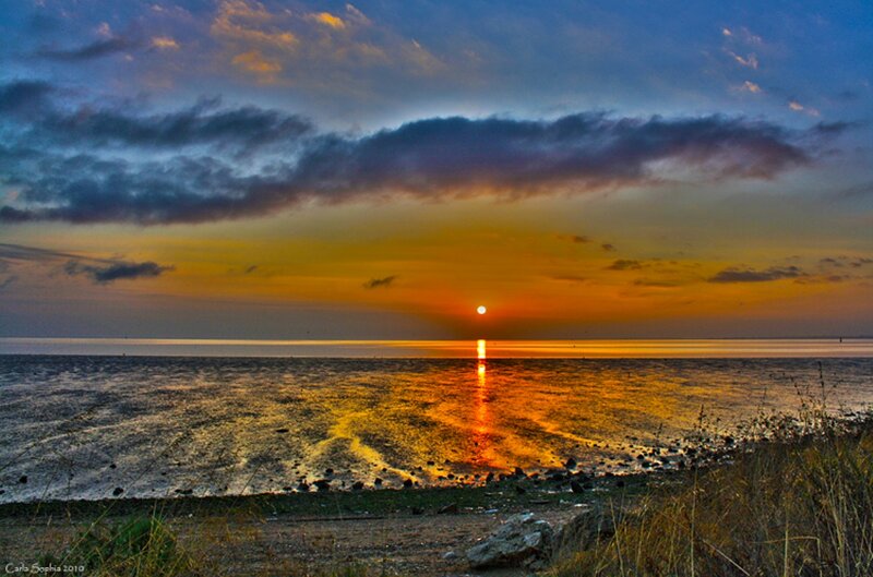 Sunset over Coastal Water — Orange, Dramatic, Photograph