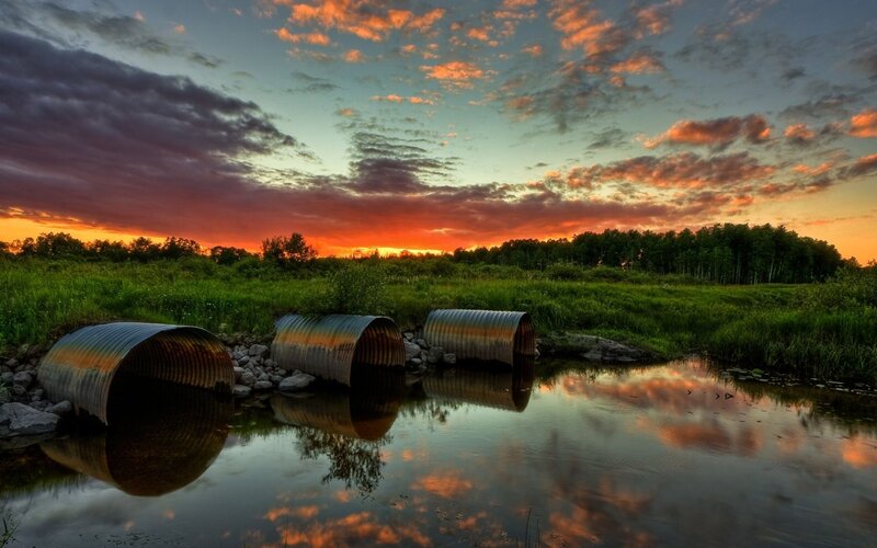 Sunset over corrugated pipes