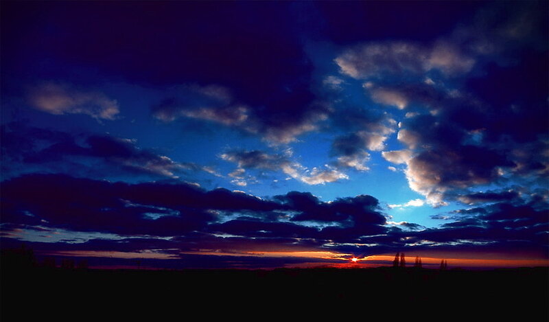 Sunset over Dark Landscape — Blue