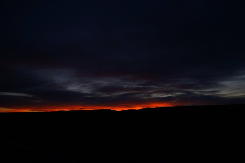 sunset over dark landscape