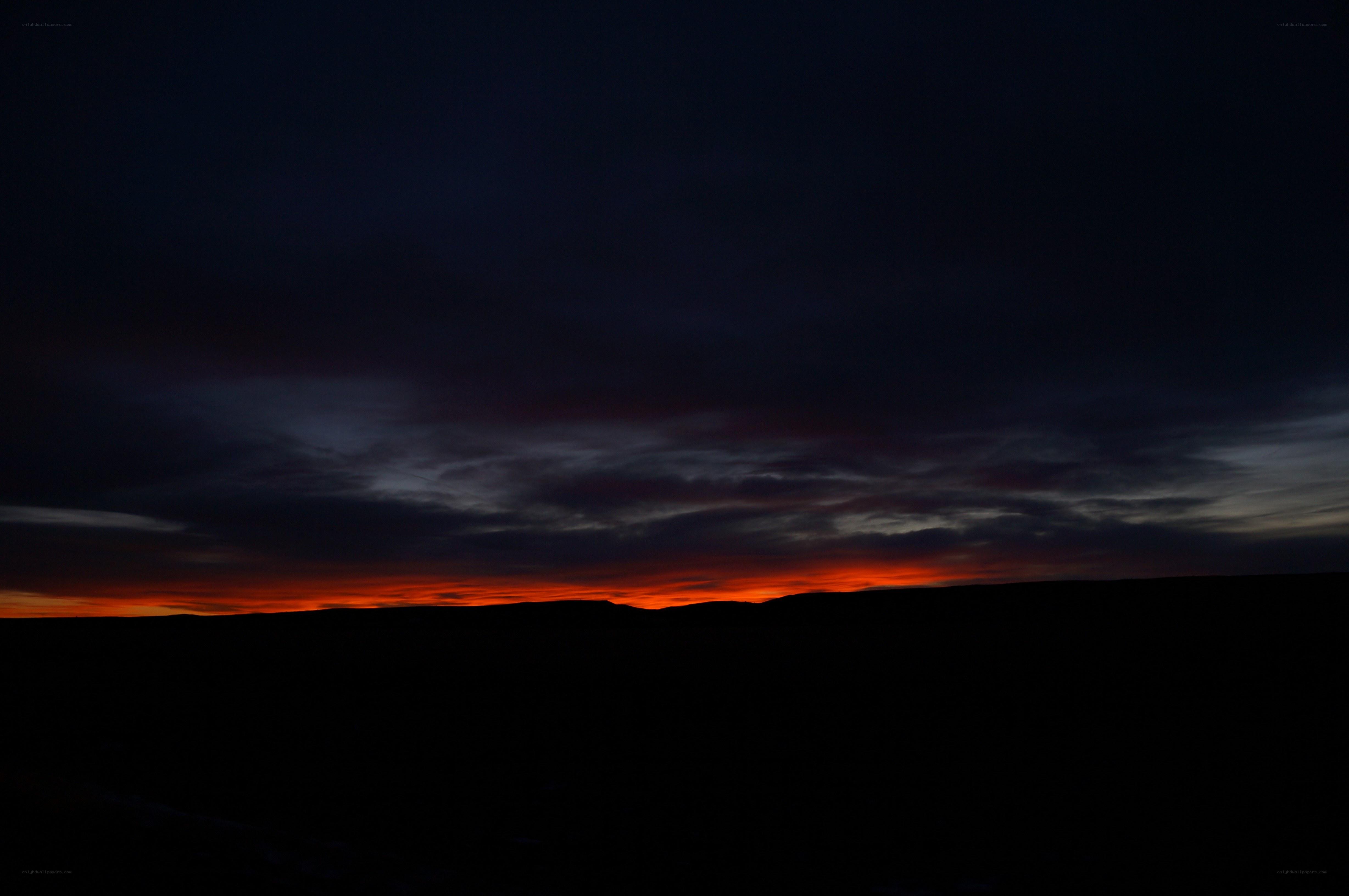 sunset over dark landscape
