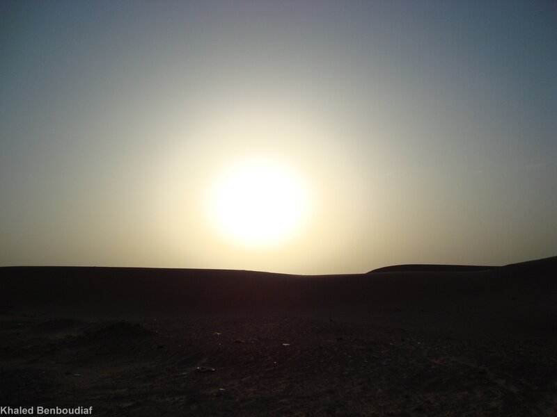 Sunset over desert dunes