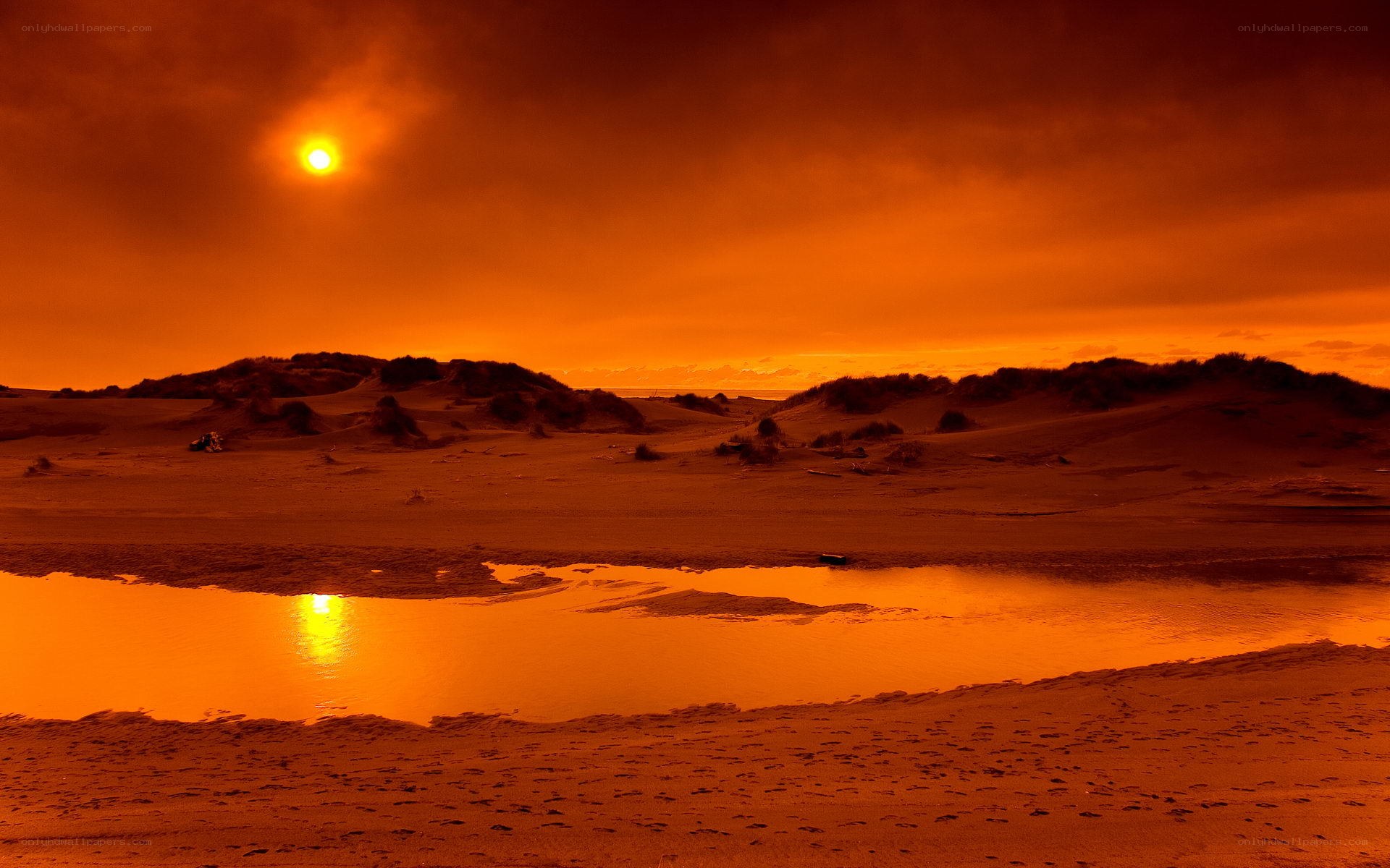 sunset over dunes and water