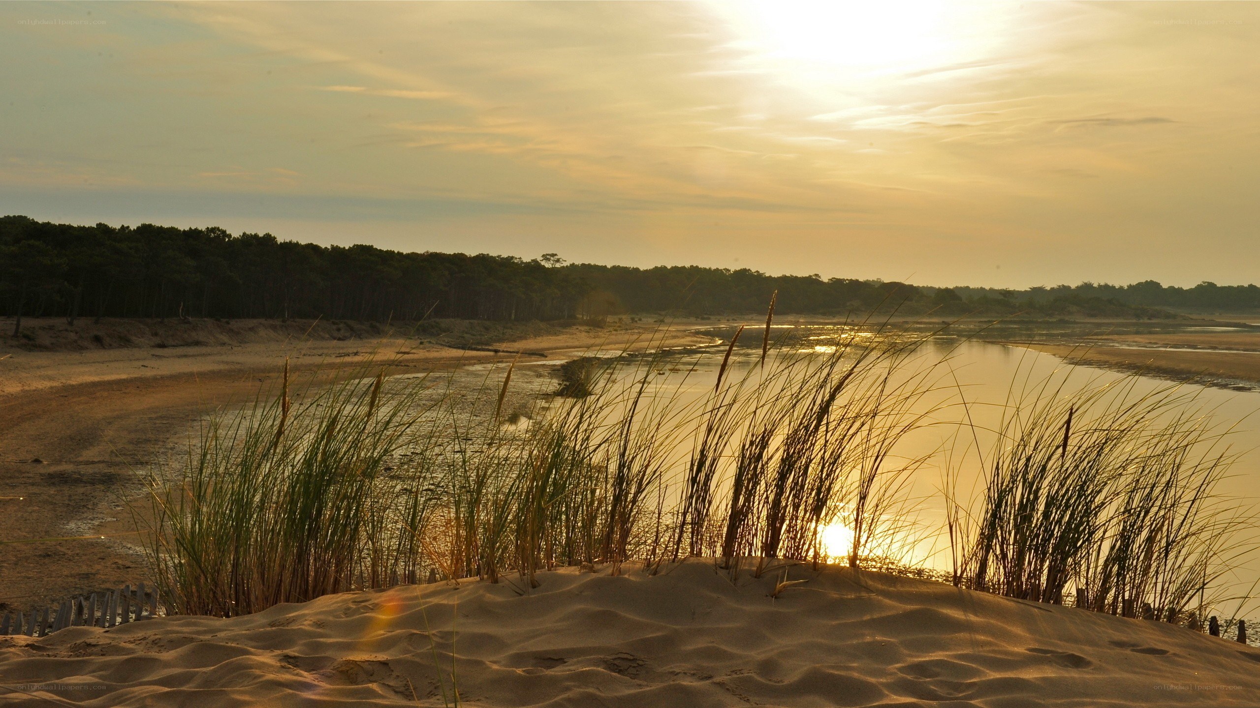 sunset over dunes and water