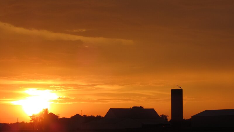 sunset over farm silo