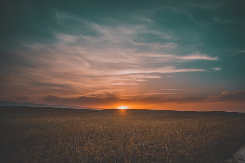 Sunset over Field — Orange, Serene, Photograph, Mountains, Sky
