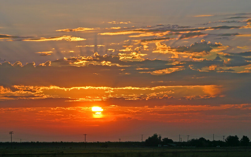 Sunset over Fields — Orange, Dramatic, Photograph, Clouds, Sun, Power Lines, Trees