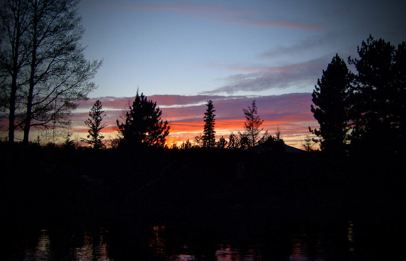 sunset over forest and lake