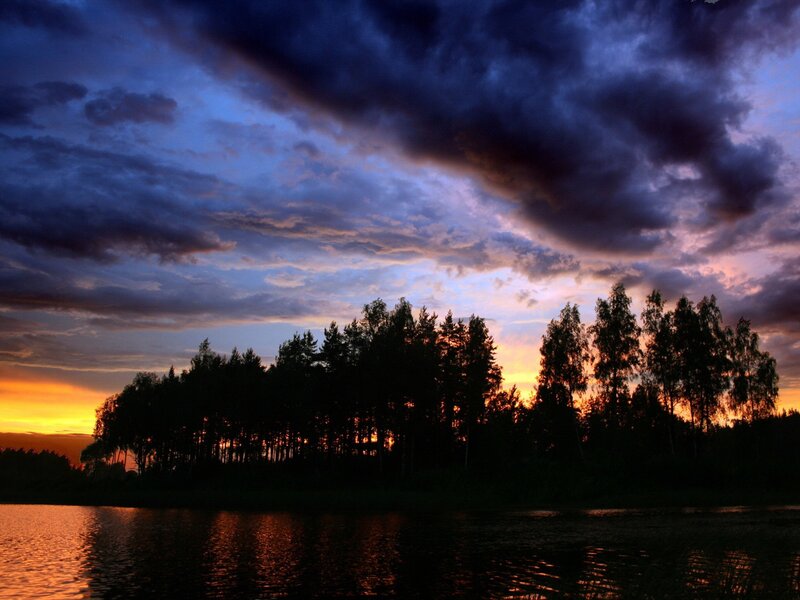 Sunset over forest lake