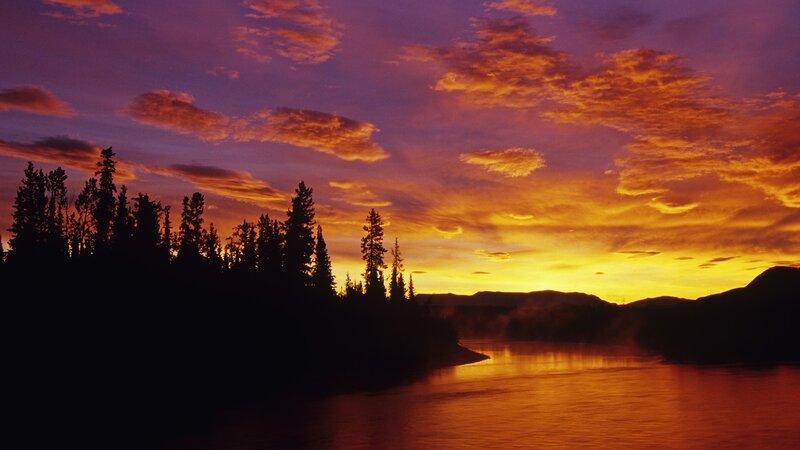 Sunset over forest river