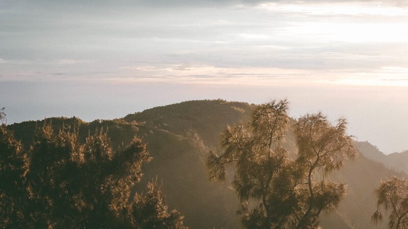 Sunset over forested hills