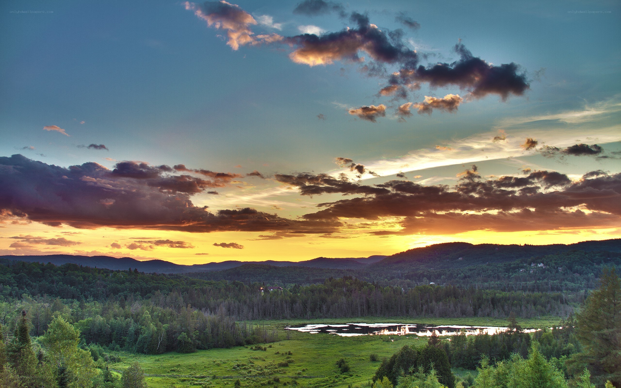 Sunset over forested hills