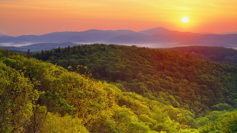Sunset over forested hills