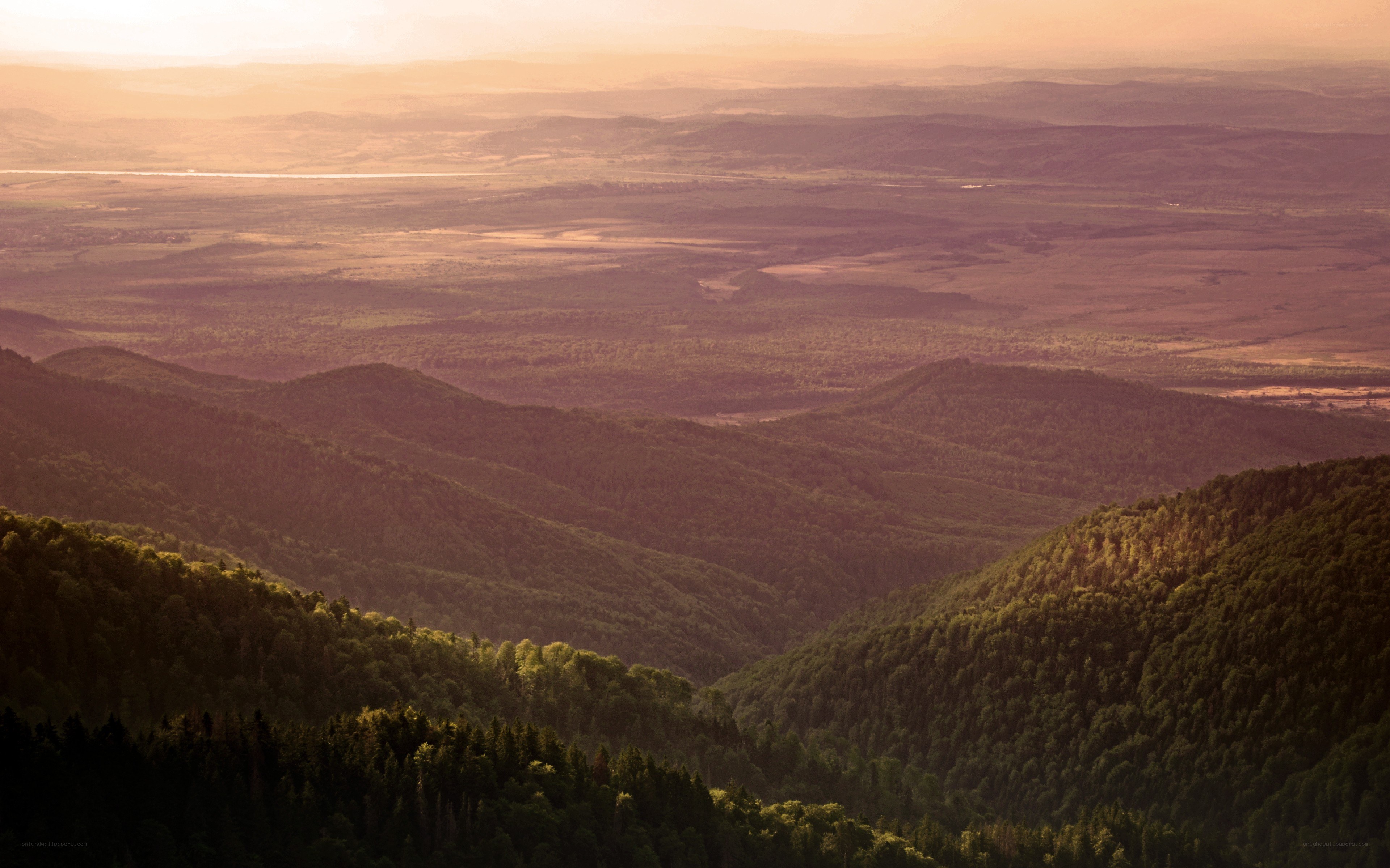 Sunset over forested hills