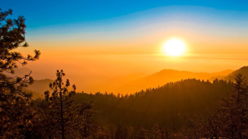 Sunset over forested mountains