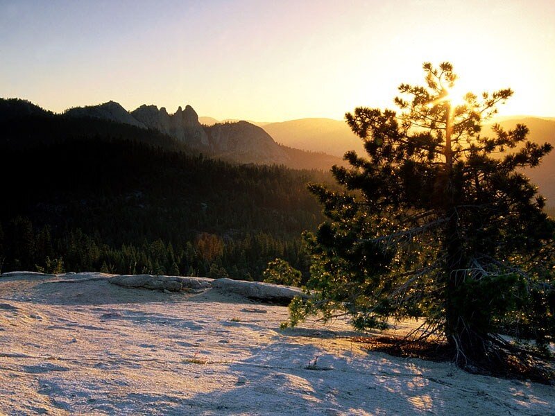 Sunset over forested mountains