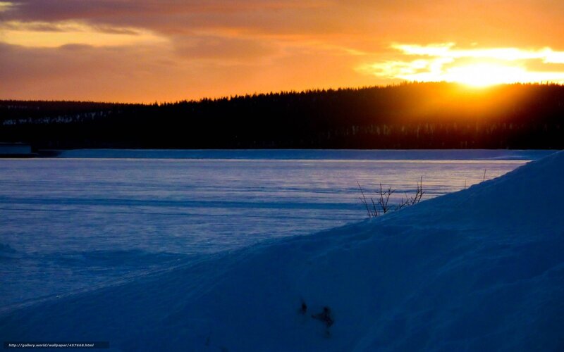 Sunset over frozen lake