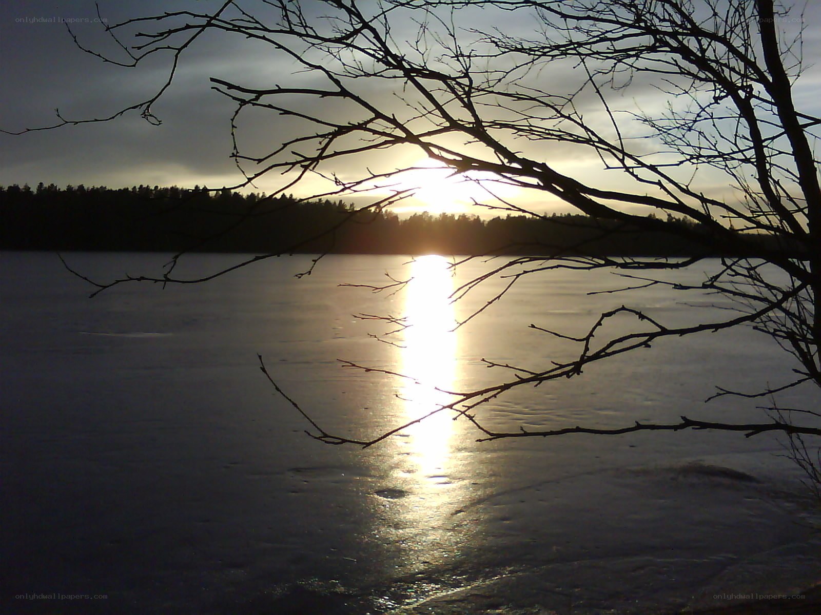 Sunset over frozen lake