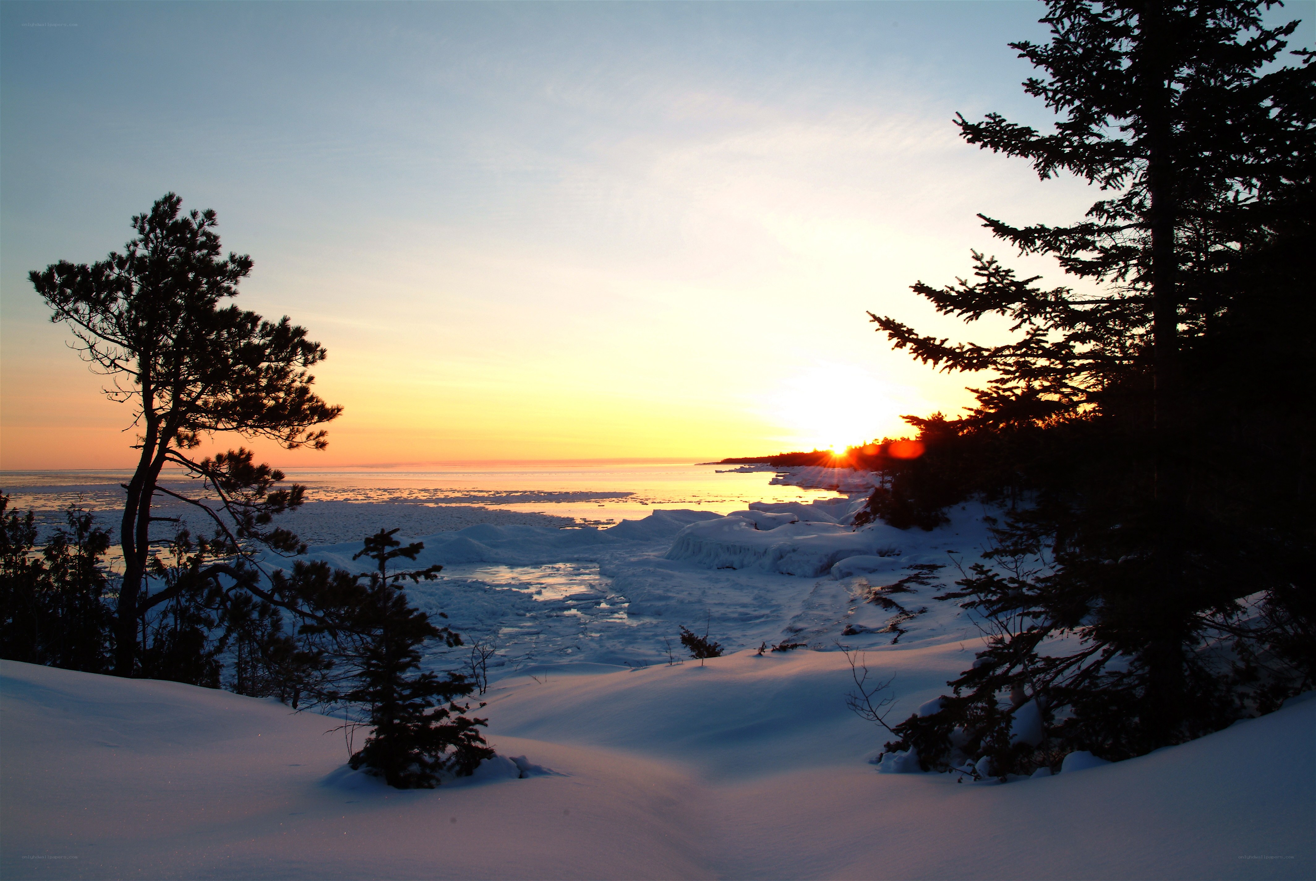 Sunset over frozen lake