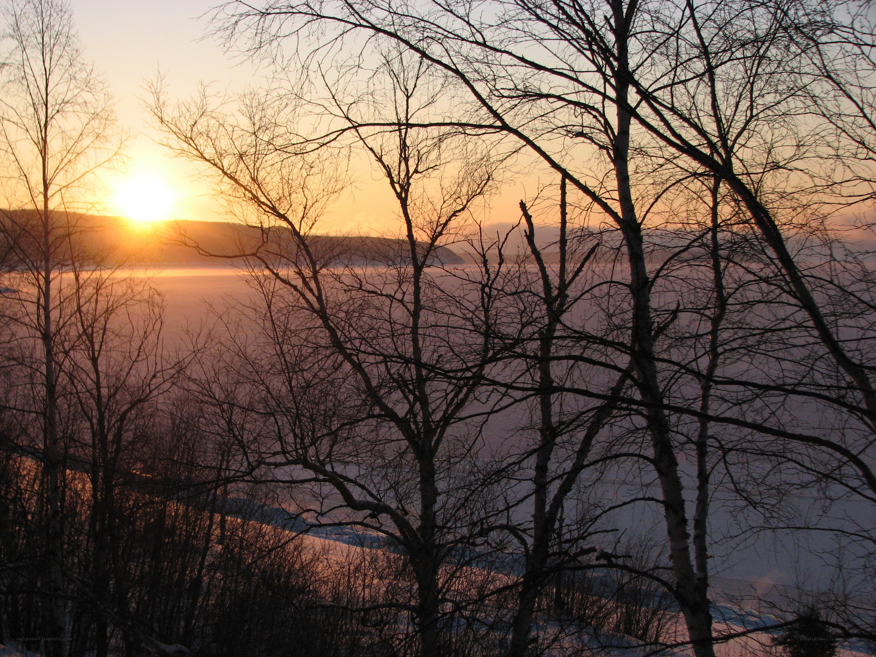 Sunset over frozen lake