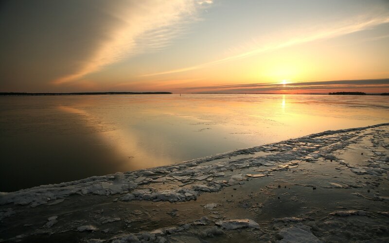 Sunset over frozen lake