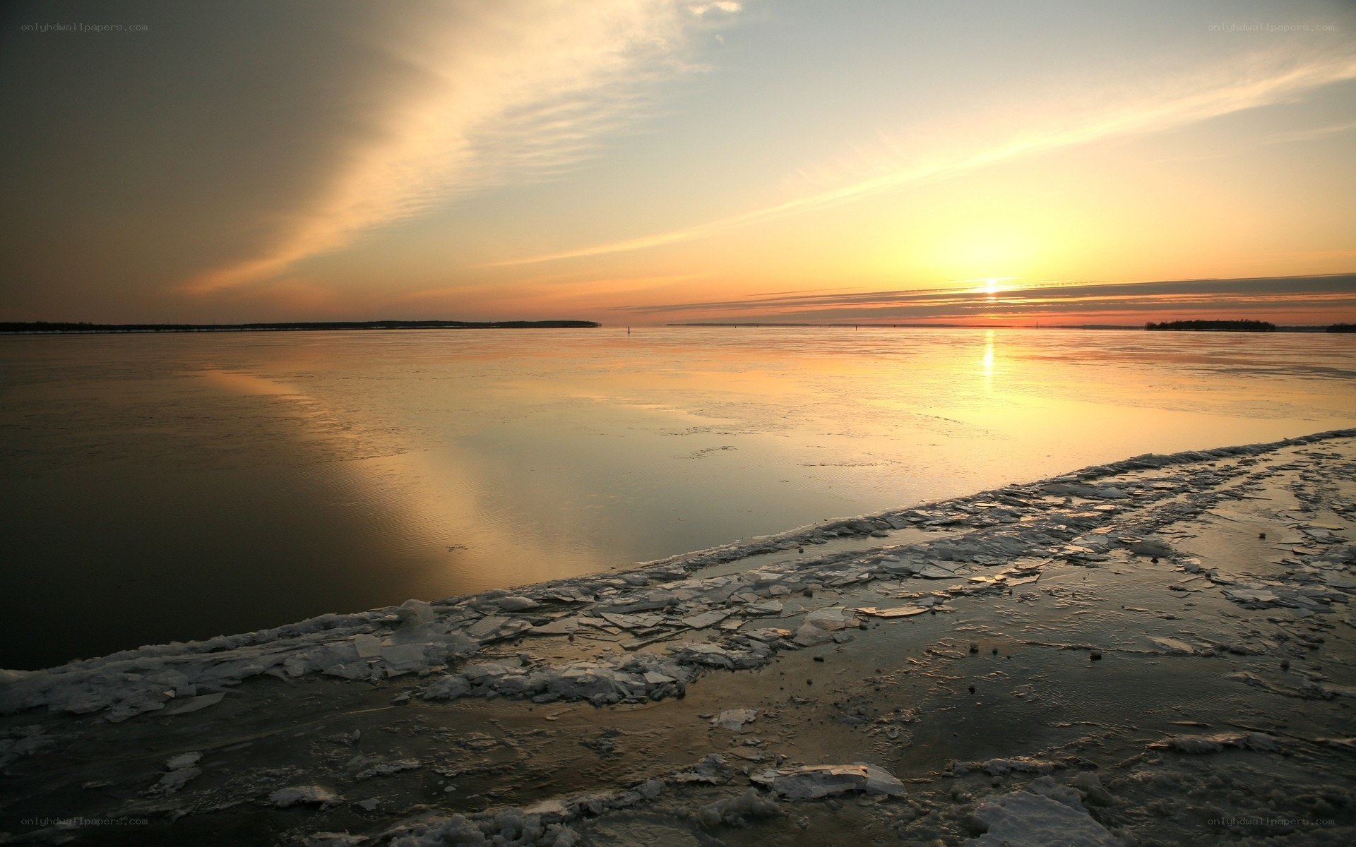 Sunset over frozen lake
