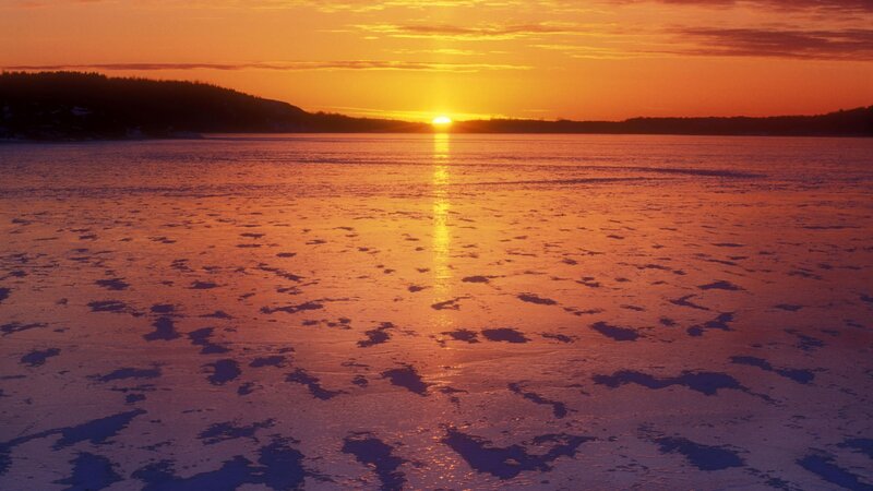 Sunset over frozen lake