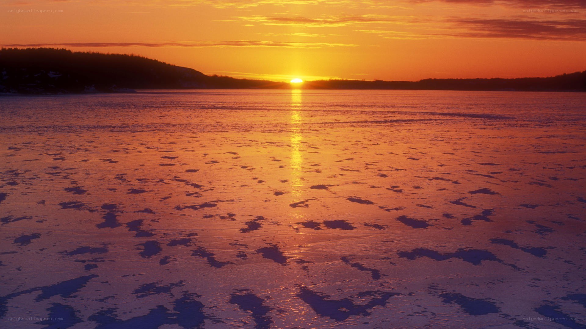 Sunset over frozen lake