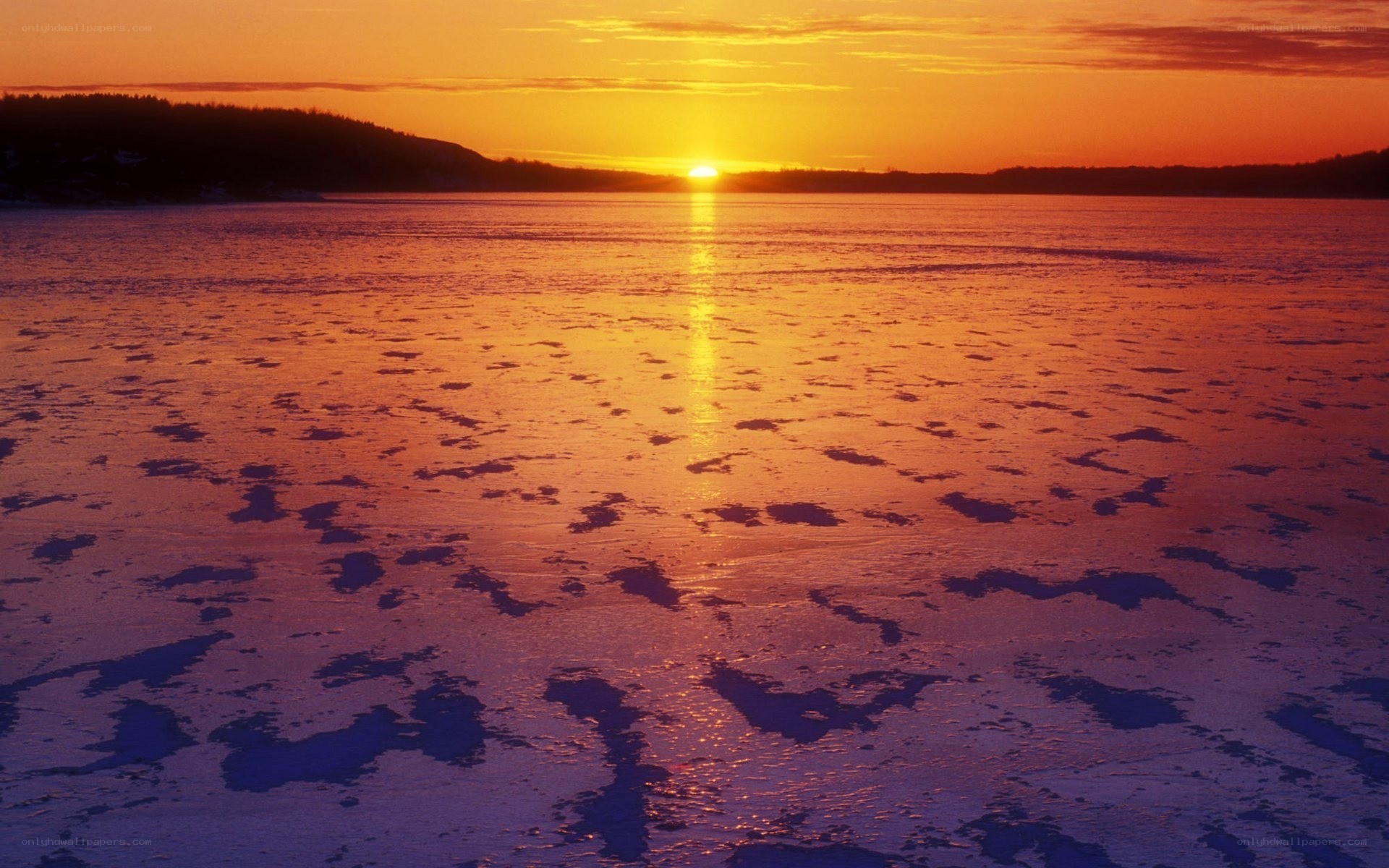Sunset over frozen lake