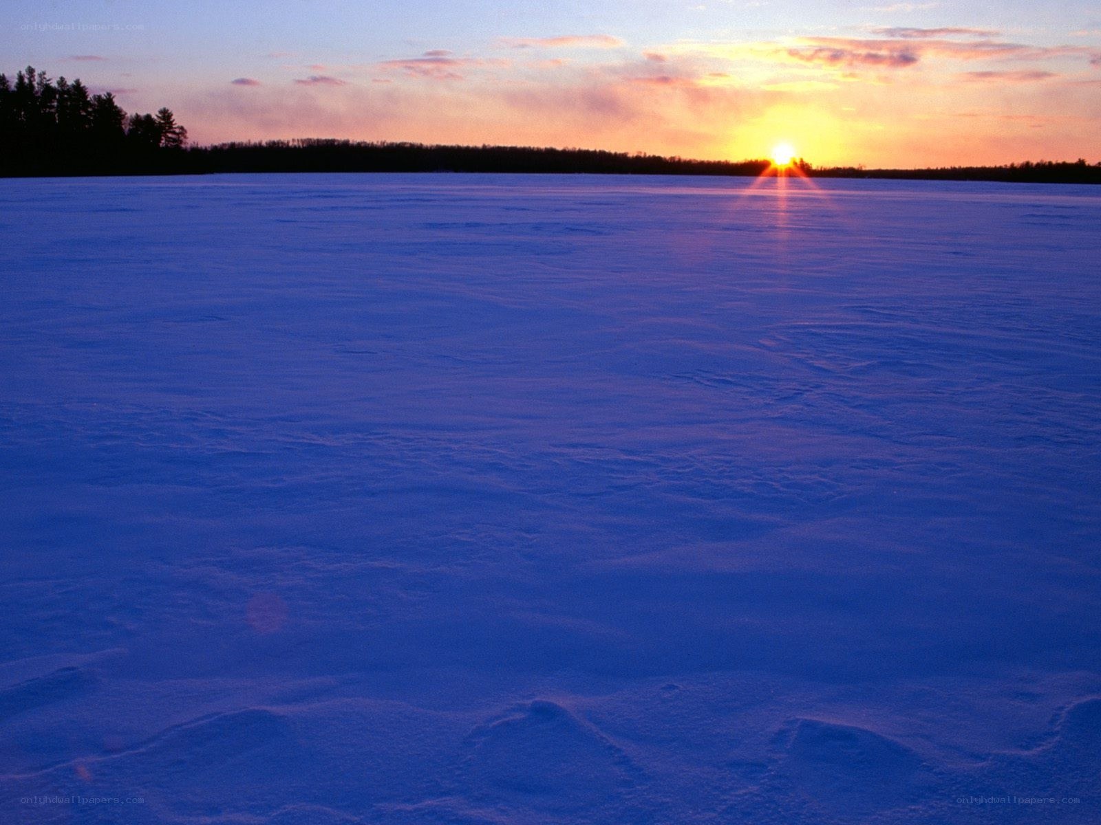 Sunset over frozen lake