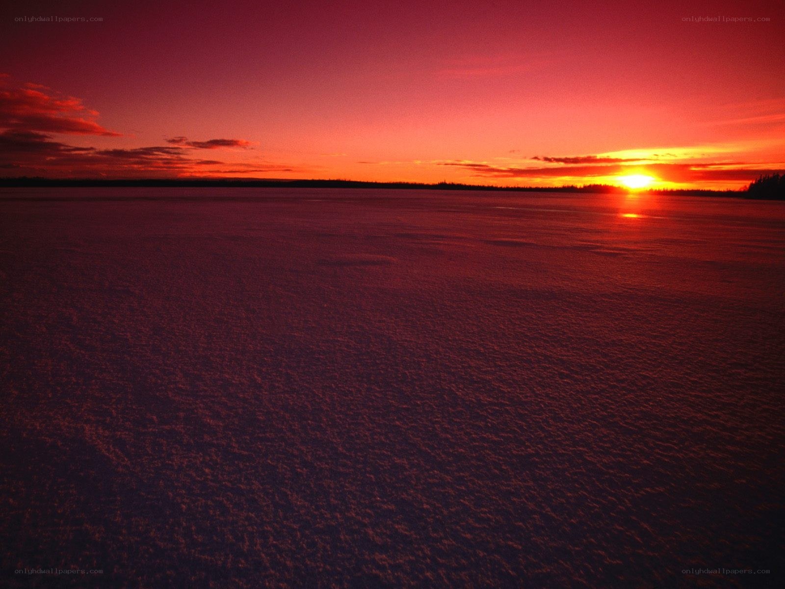 Sunset over frozen lake