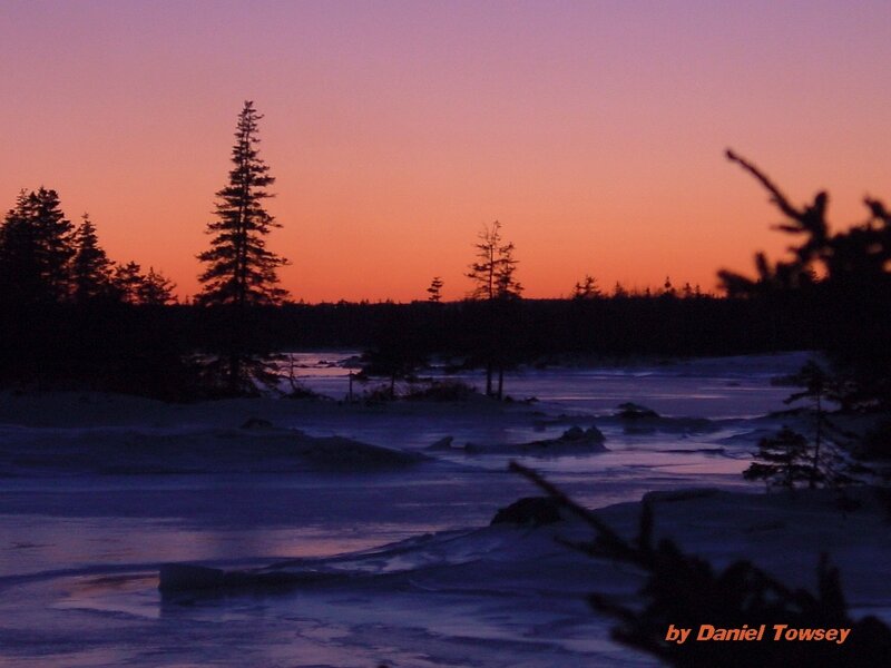 sunset over frozen lake