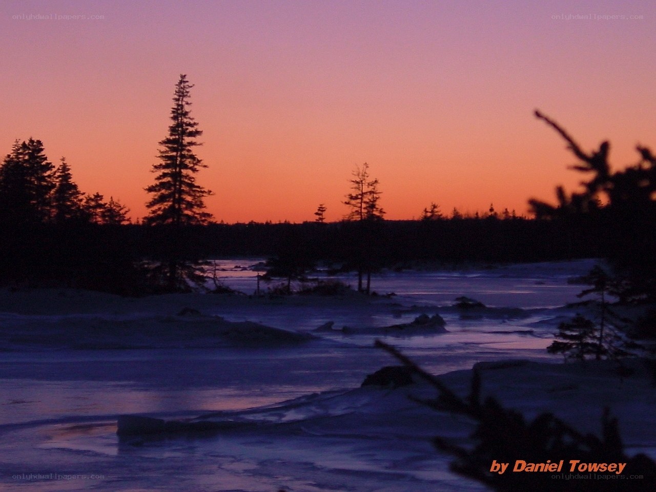 sunset over frozen lake