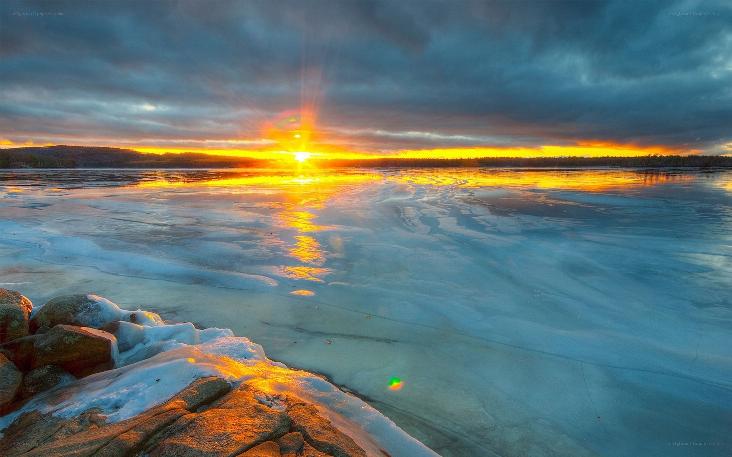 Sunset over frozen lake