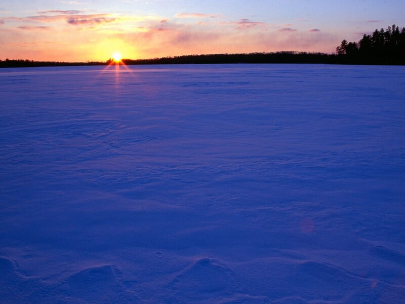 Sunset over frozen lake