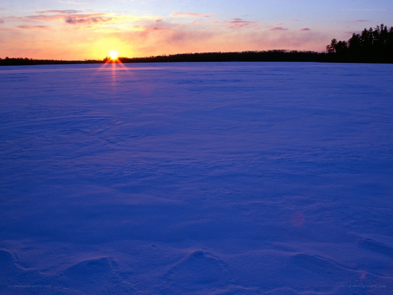 Sunset over frozen lake