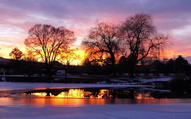 Sunset over frozen pond