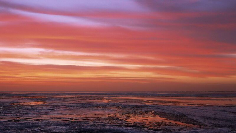 sunset over frozen sea