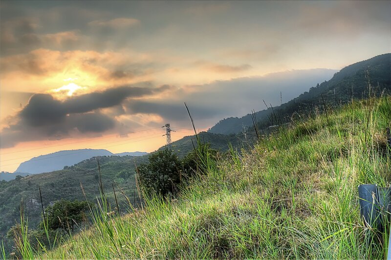 Sunset over grassy hills