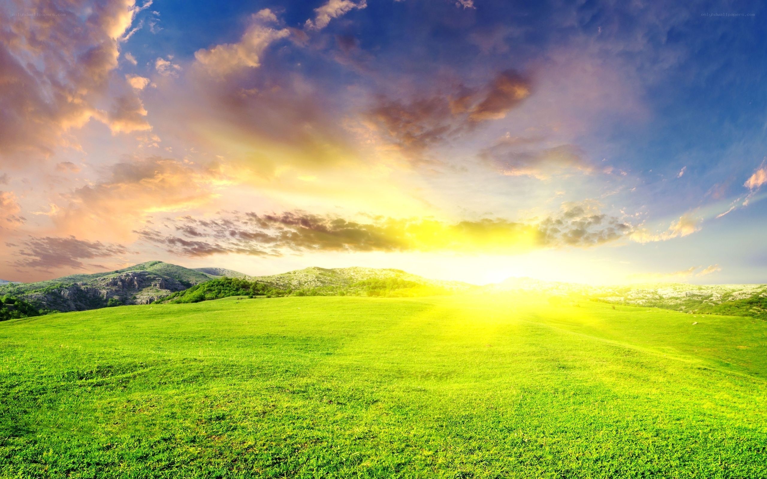 Sunset over green hills