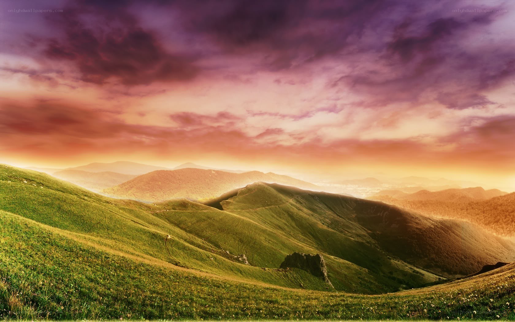Sunset over green hills