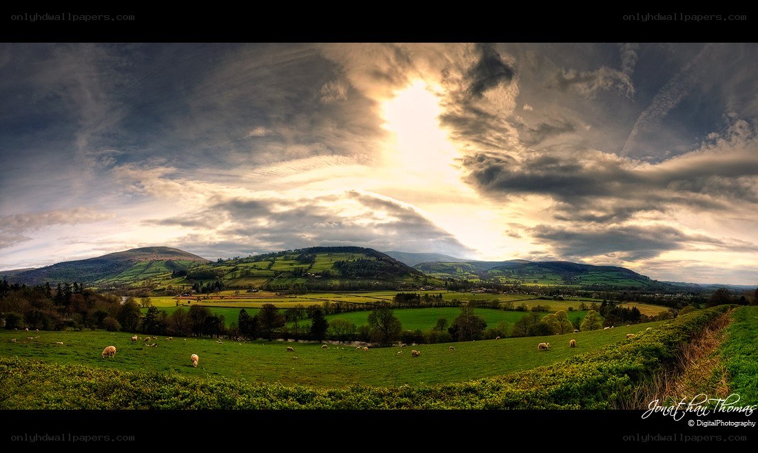 Sunset over green hills