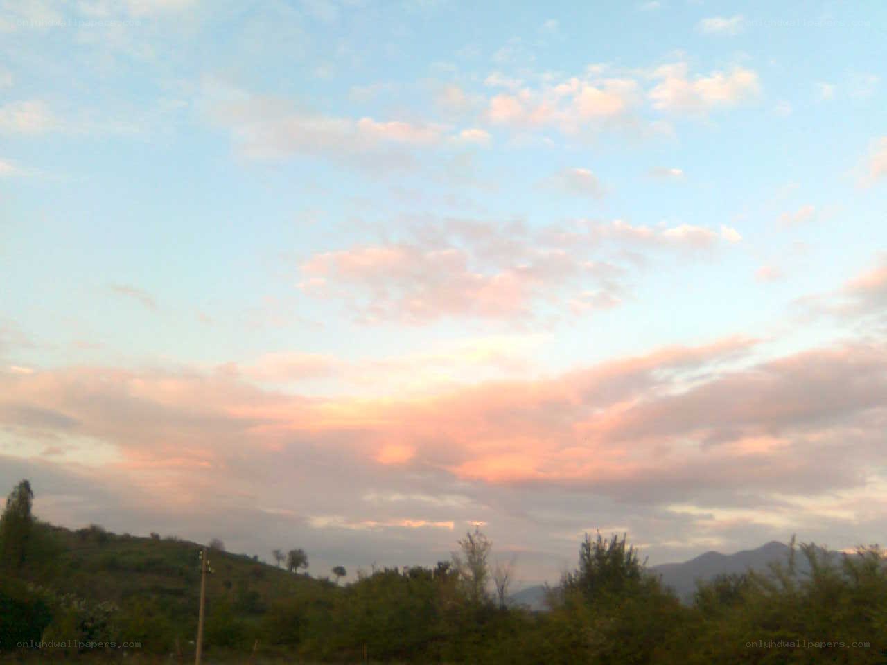 Sunset over green hills