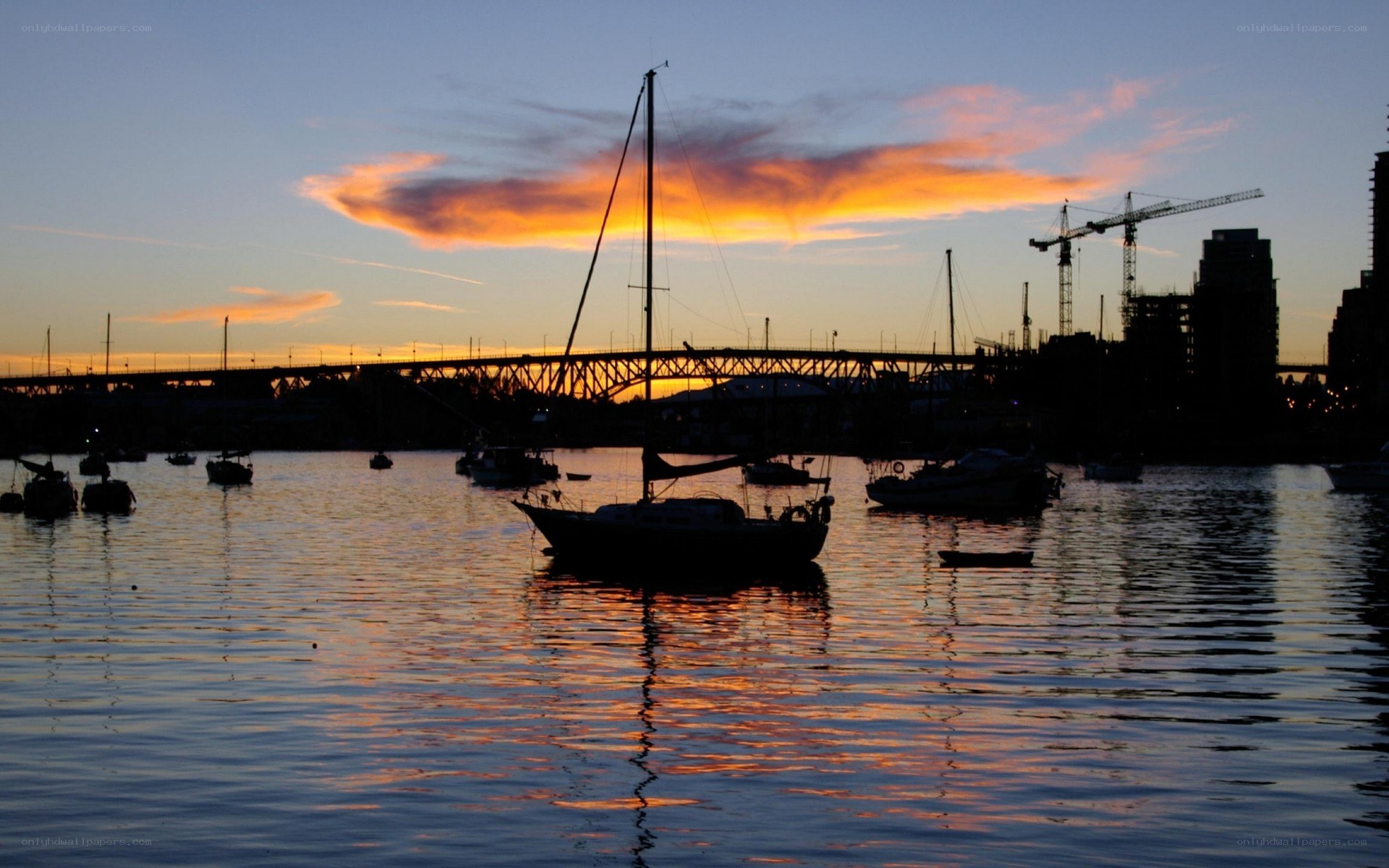 sunset over harbor with boats